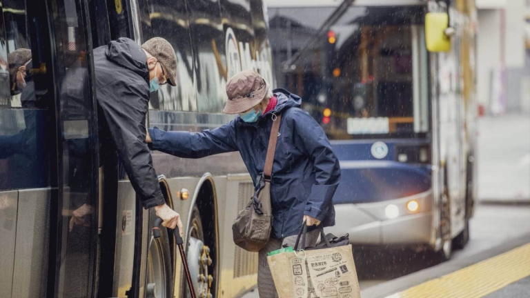 Old couple taking public transport