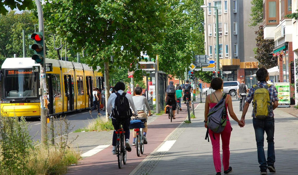 Pedestrians walking and biclycles in a sidewalk